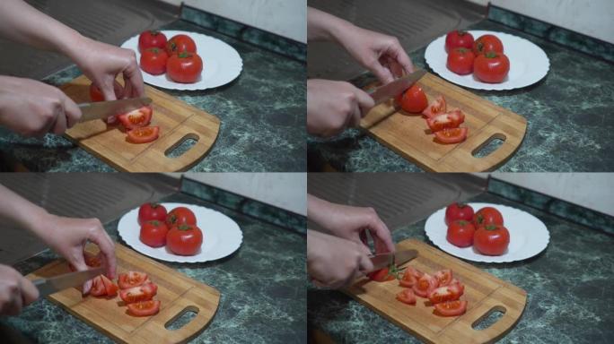 女性高加索人用菜刀切番茄的极端特写。面目全非的女人准备新鲜的有机素食。烹饪，烹饪，烹饪