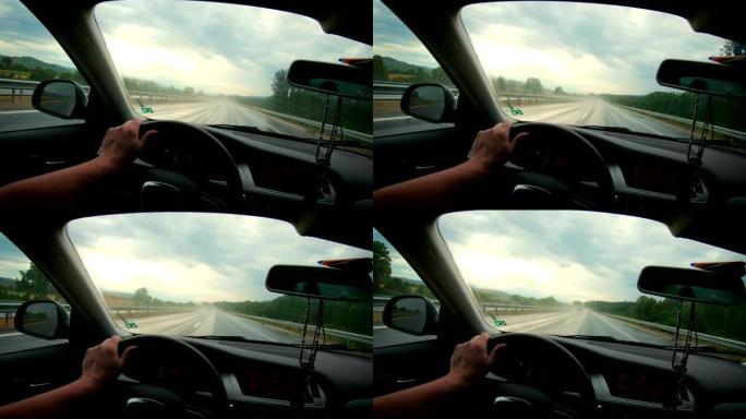 男子在雨中在高速公路上行驶