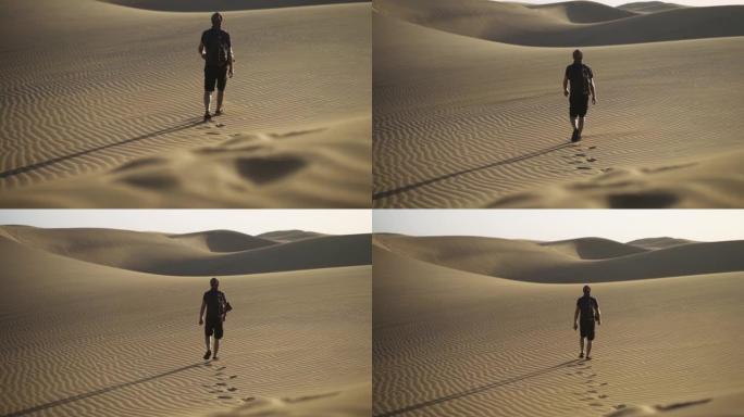 在沙漠中行走的人的脚印
