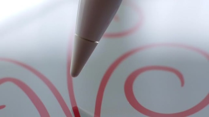 宏观跟随艺术家用铅笔在数字平板电脑上绘画的镜头。铅笔连接到相机。抓拍。