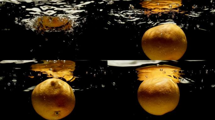 橙色葡萄柚溅入水中。