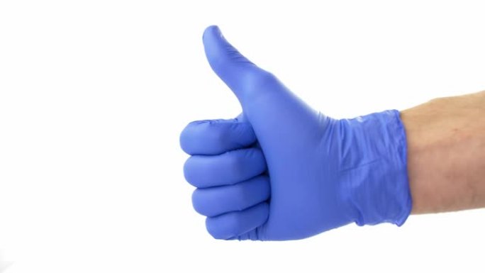 竖起大拇指信号显示在白色背景的蓝色防护手术手套中