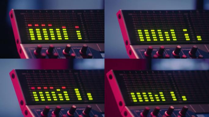 音响工程师在录音室中与声音控制台一起工作