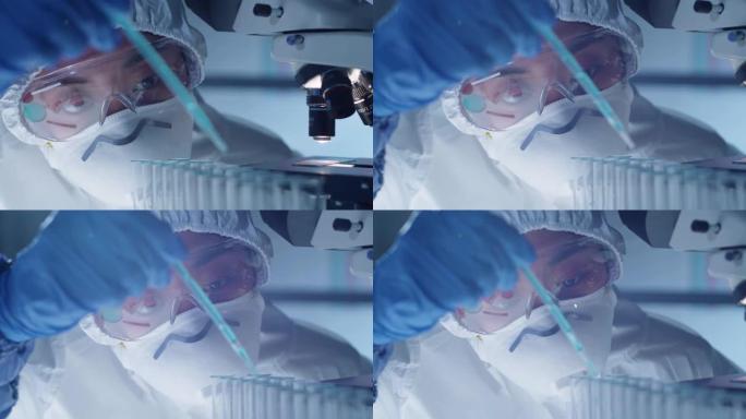 亚洲女研究员在实验室将蓝色液体滴入试管