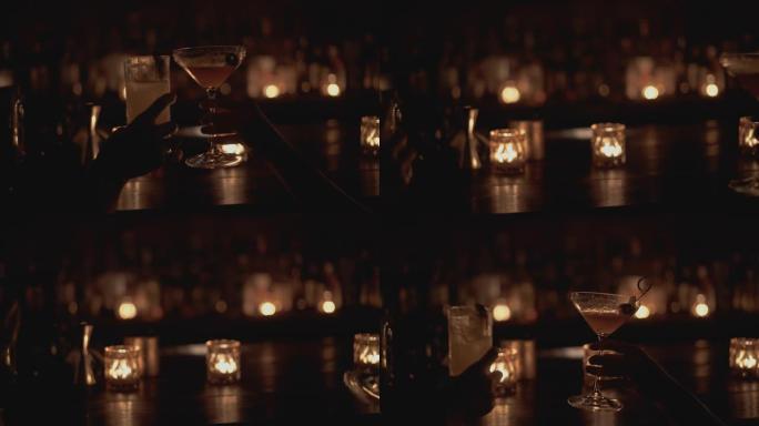 曼谷一家酒吧的酒吧柜台特写镜头。人类喝鸡尾酒，蜡烛在背景中燃烧