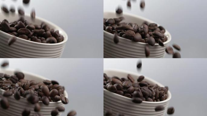 慢动作落下的咖啡豆。装满咖啡豆的咖啡杯