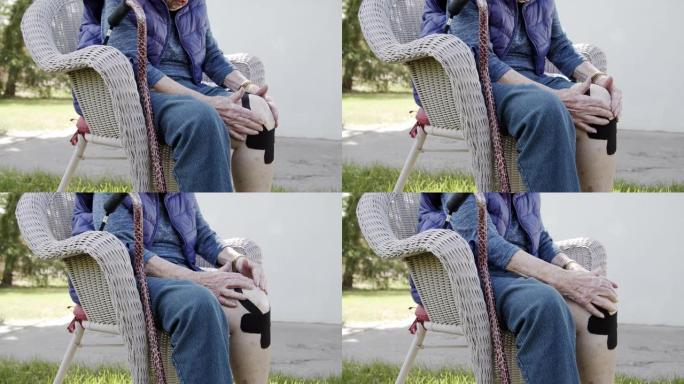 夏季户外中午，老年高加索妇女的膝关节关节炎疼痛的特写镜头