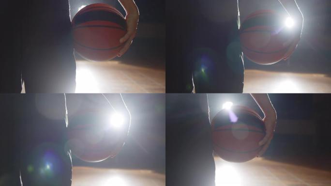 篮球运动员手持球的特写明亮光影剪影