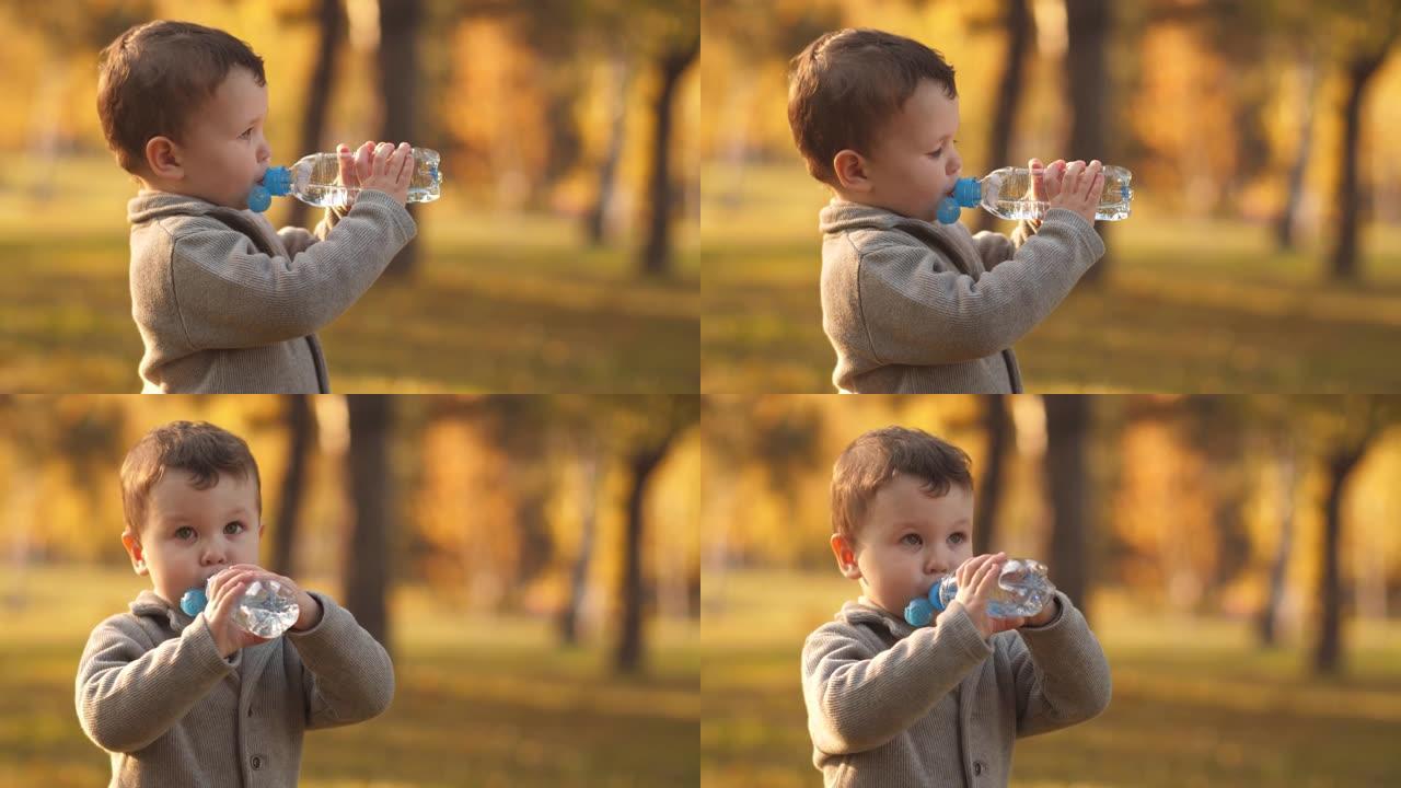小男孩在大自然上喝水