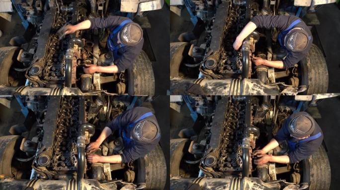 男子修理卡车的发动机