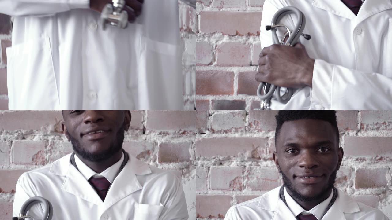 手握听诊器的特写镜头，由一名身穿白色白大褂的黑人男医生站在红砖墙上举起。冠状病毒，流行病，大流行，新