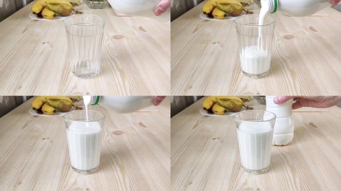 开菲尔，酸牛奶或白喝酸奶从瓶子中倒入多面玻璃中