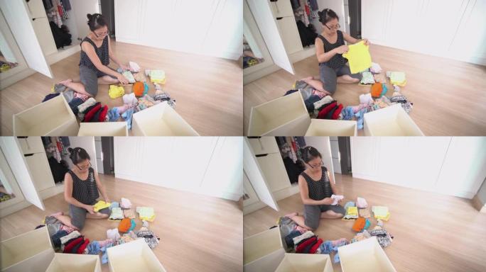 亚洲女子在家更衣室折叠婴儿布