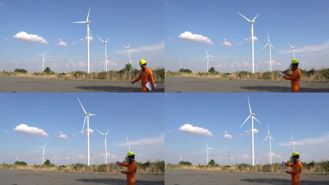 在风力涡轮机农场工作的女工程师的剪影