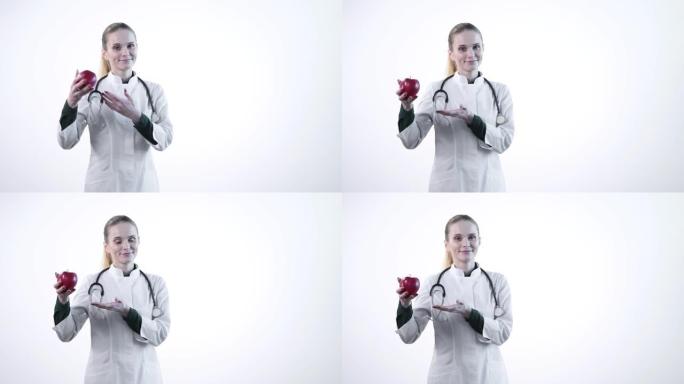 一位有吸引力的女医生要求适当的营养。手里拿着红苹果。