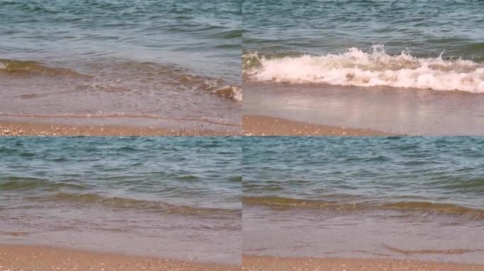 海滩，泡沫海洋，海浪洗沙。海浪冲击沙滩。海浪的声音