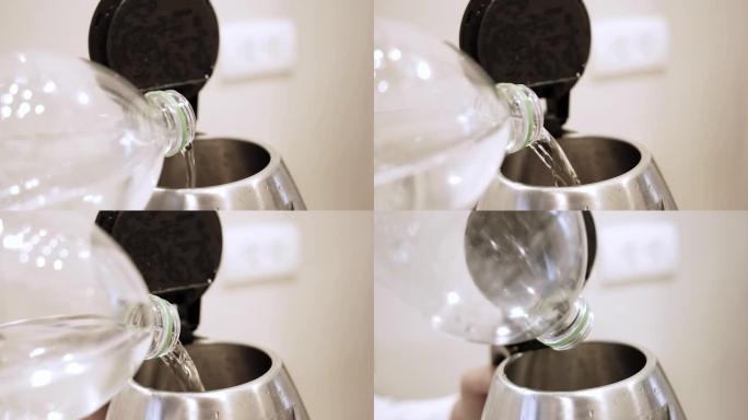 一个人的手将水从瓶子倒入厨房的电热水壶的特写镜头。