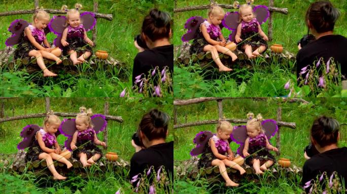 摄影师拍摄可爱的女孩玩蝴蝶和吃蜂蜜的照片