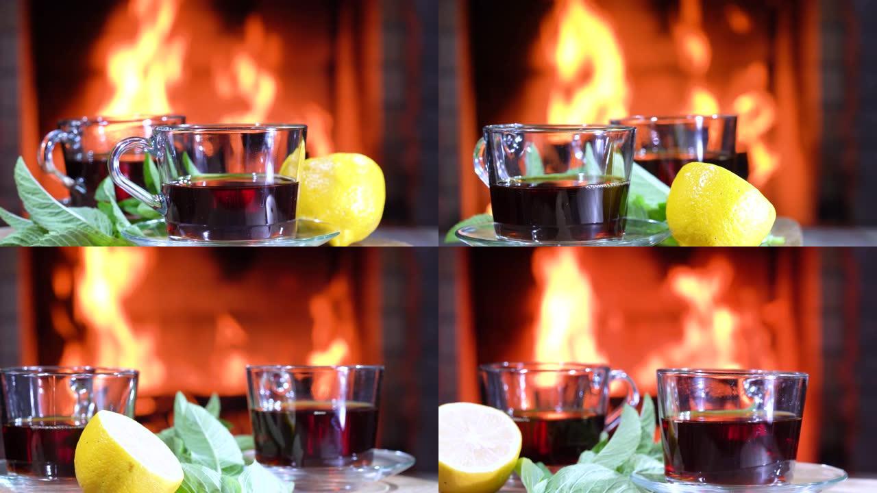 杯子里装有柠檬和薄荷的茶在乡间别墅燃烧的壁炉前旋转。