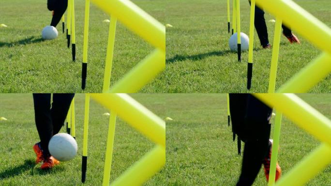 足球敏捷训练设备。足球运动员在敏捷杆中运球。4k慢动作