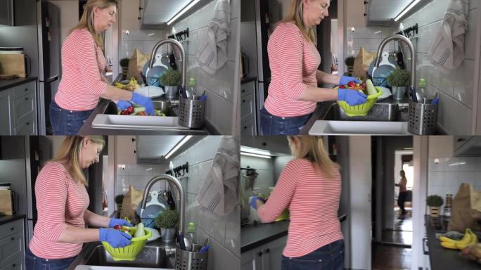 戴防护面罩和手套洗菜的女人