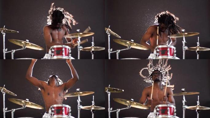 充满活力的非洲鼓手在情感上演奏打击乐器