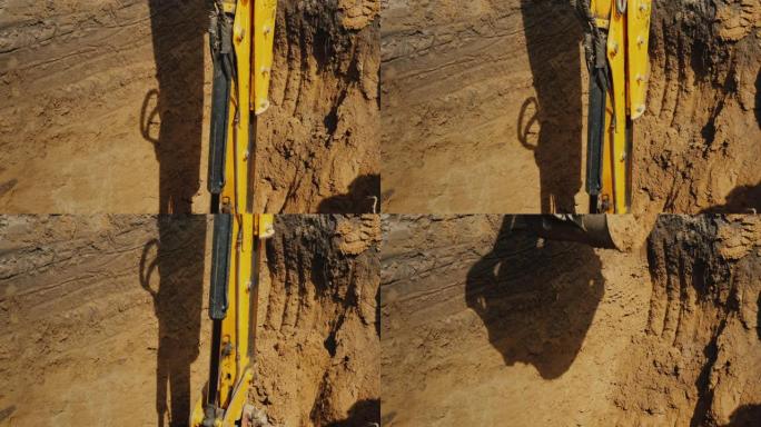 挖掘机铲斗从深沟中提取地面