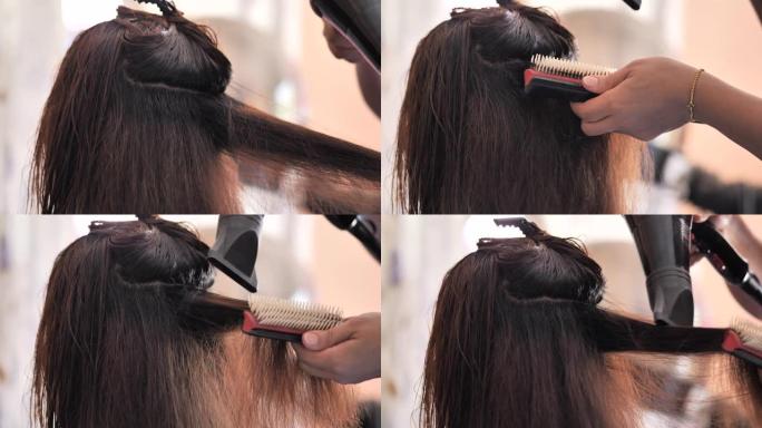 理发师在吹干顾客头发时使用吹风机和圆刷。