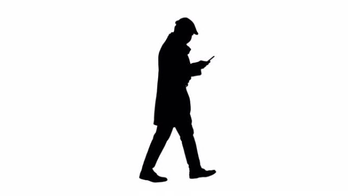 戴着医用口罩的剪影男子走路和使用手机