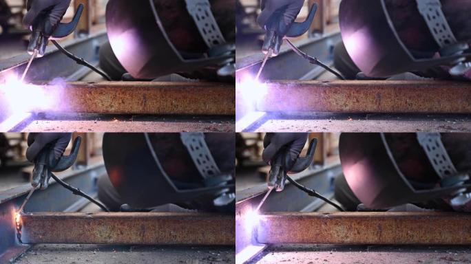 两个金属零件的焊接过程的特写。