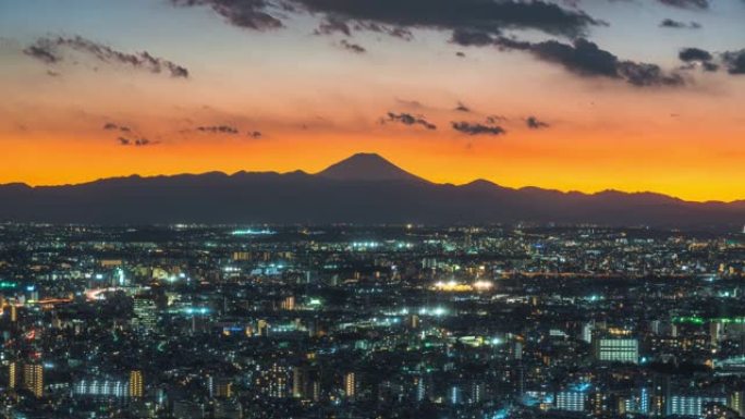 4k延时: 日本东京，市区首府城市和富士山背景的摩天大楼和繁忙交通的昼夜景观