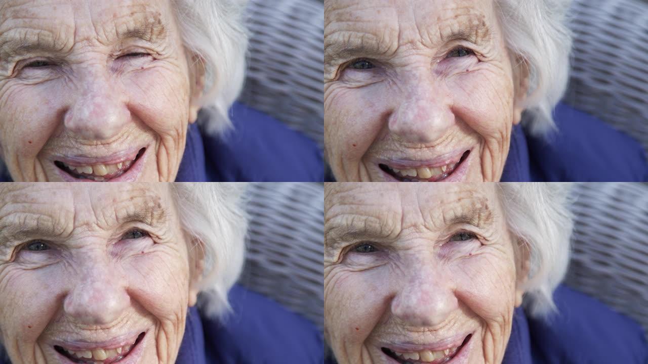 微笑拍摄美丽，敏锐，聪明的老年高加索妇女独特的斑点漂亮的眼睛和脸在夏天的户外