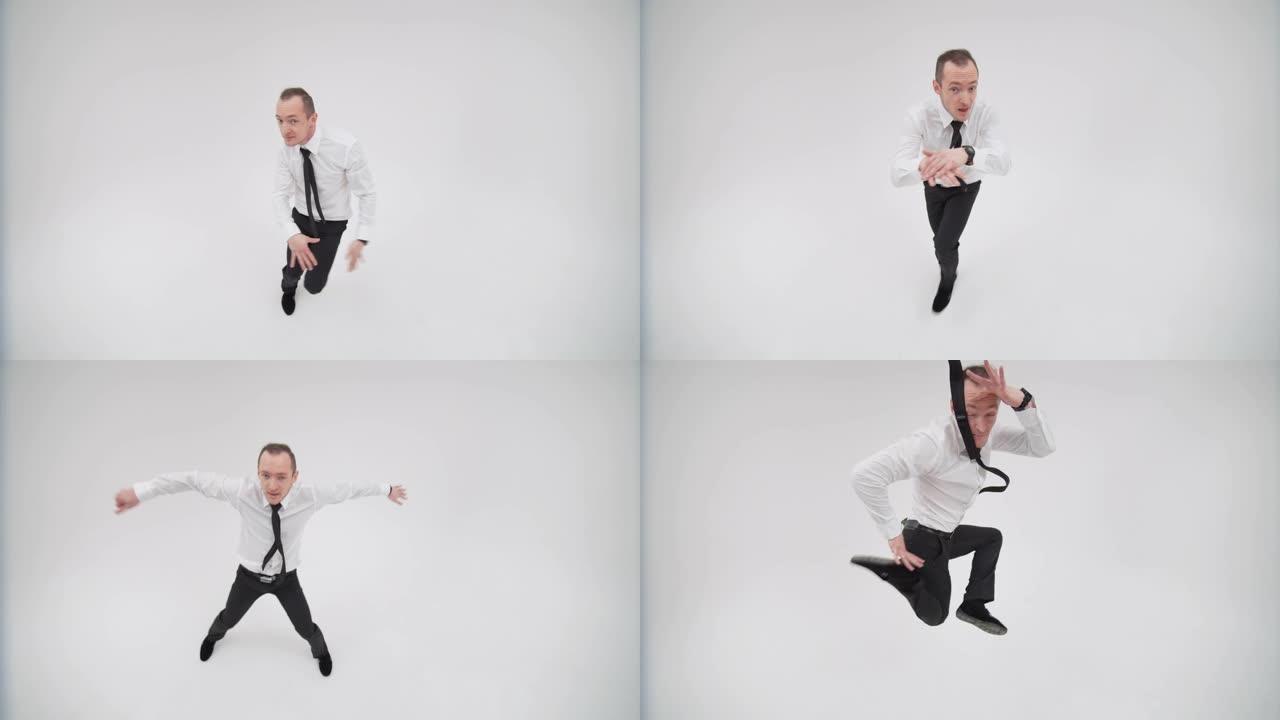 一个商人跳霹雳舞，看着相机的俯视图。办公室工作人员跳舞霹雳舞抬头
