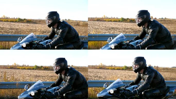 年轻人在高速公路上骑着现代运动摩托车。摩托车手在乡村公路上骑摩托车。旅途中开车的人。自由和冒险的概念