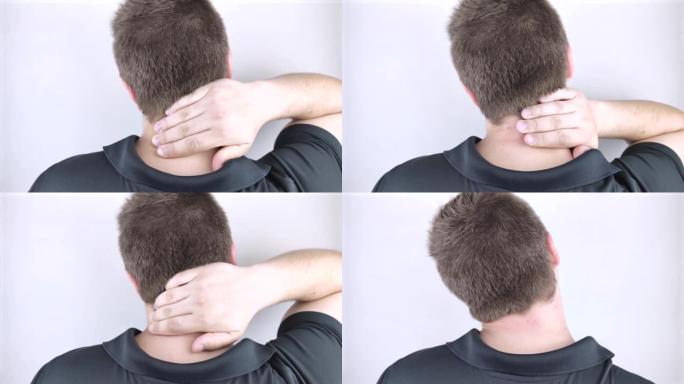 一名男子颈部疼痛，用手按摩颈椎。由于久坐工作或身体压力引起的骨软骨病，疝气或神经损伤