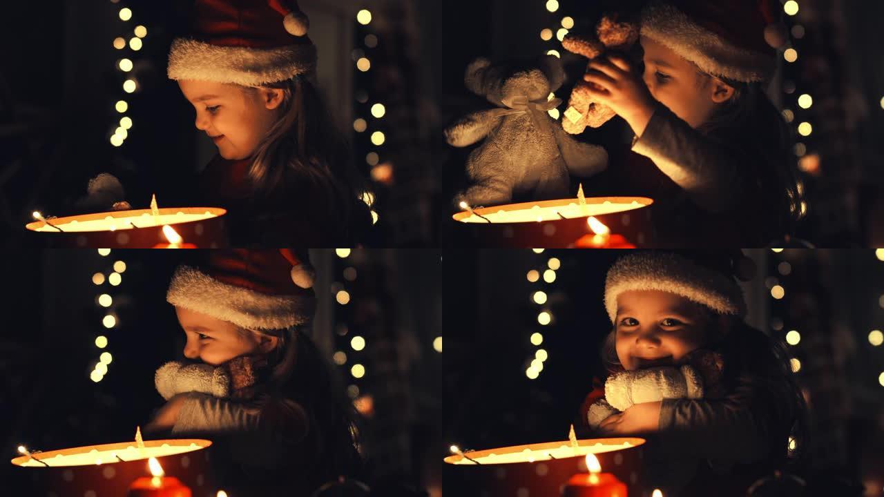 拥抱泰迪熊的漂亮小女孩她装在圣诞礼品盒里