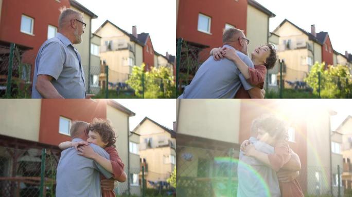 卷毛少年跑去拥抱一个白发老人。祖父和孙子在暑假见面，检疫后见面，检疫后生活