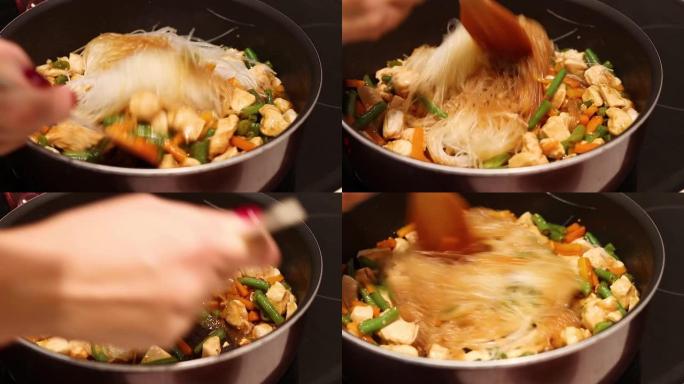 烹饪手搅动，炸鸡，火鸡配蔬菜和玻璃面