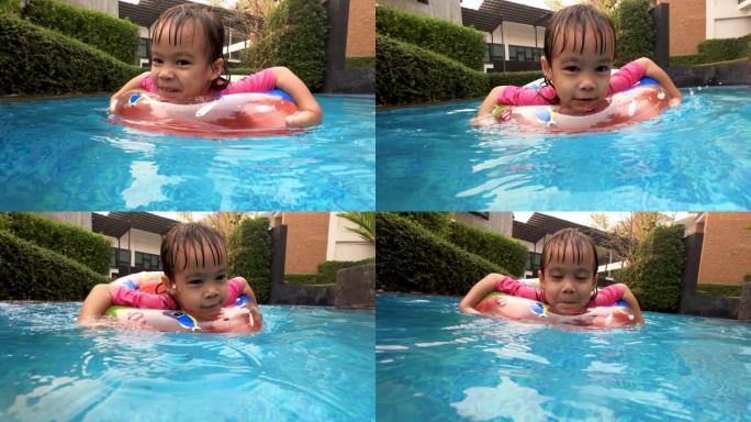 快乐的亚洲小女孩在夏天和家人在游泳池玩耍。度假中的家庭生活方式。