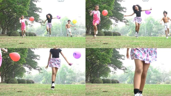 一群孩子在公园的春季野外奔跑，气球慢动作。