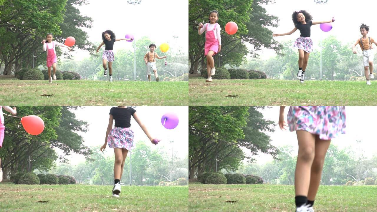 一群孩子在公园的春季野外奔跑，气球慢动作。
