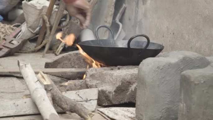 室外印度厨房在木头燃烧的火上烹饪面包。查帕蒂·纳安