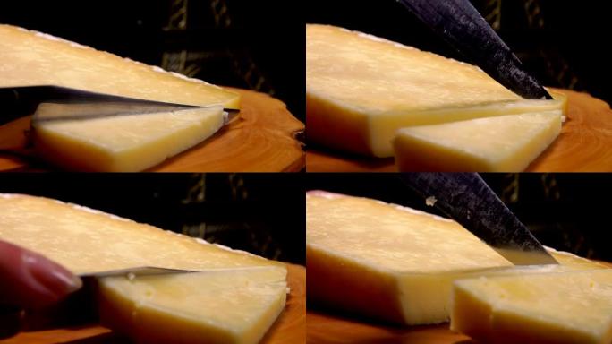 刀的特写镜头正在木板上切割法国硬奶酪