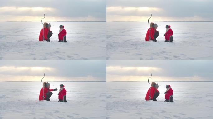 爸爸和儿子在冬天钓鱼。远射