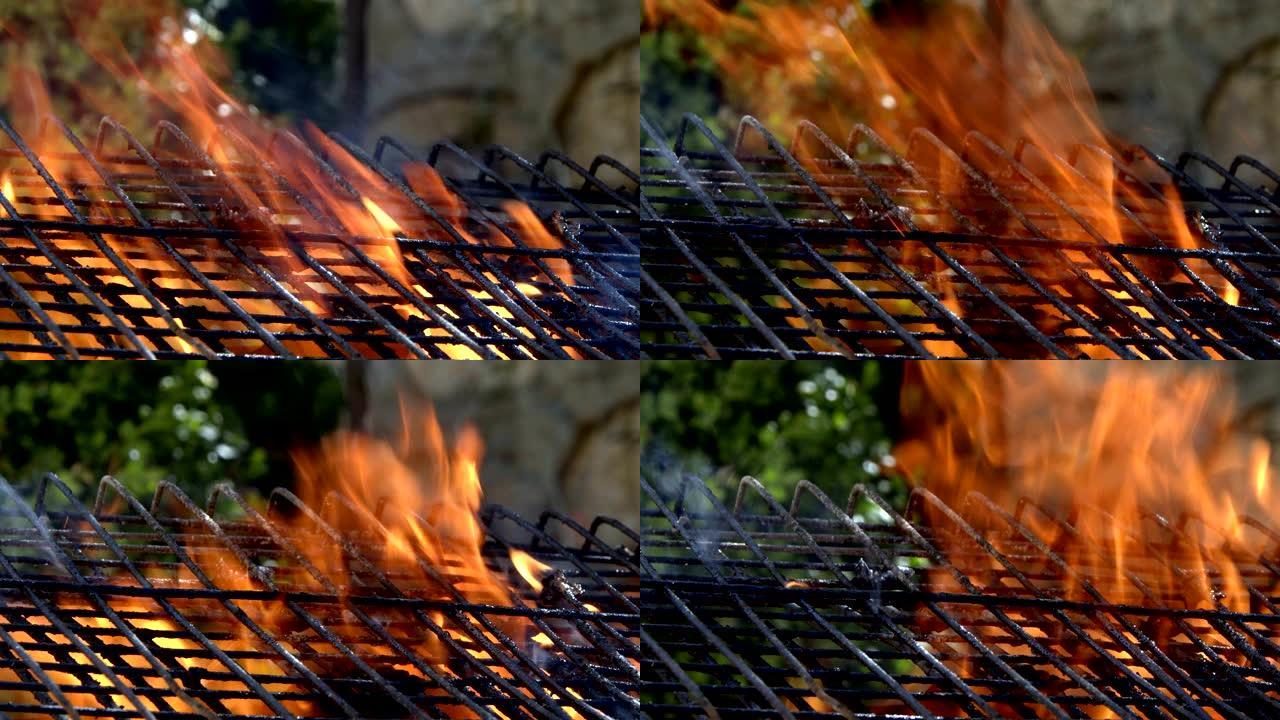 金属烧烤网格后面的木制和煤炭燃烧大火