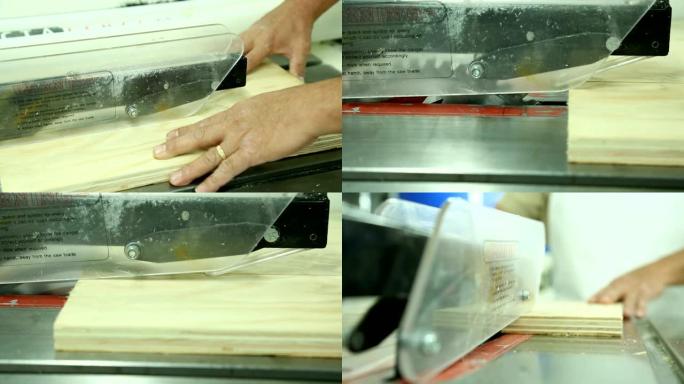 在切割木板的机器上工作的男人的手的特写