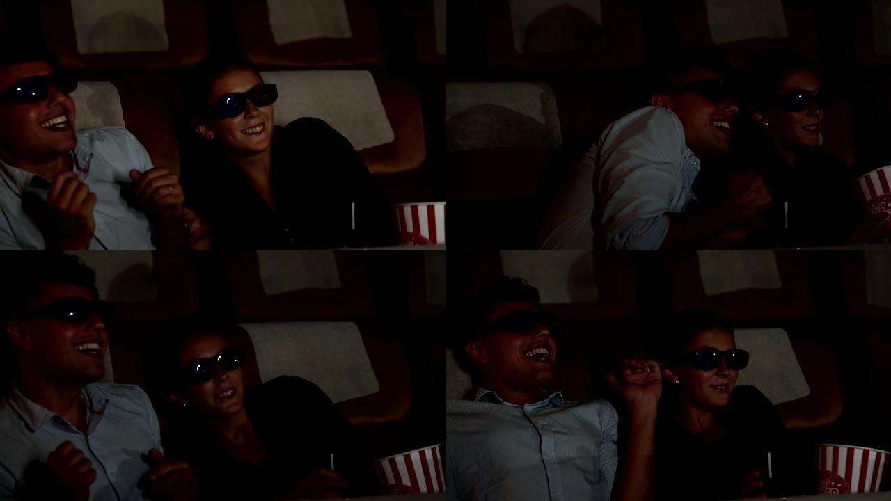 年轻夫妇在电影院看3D电影时感到幸福
