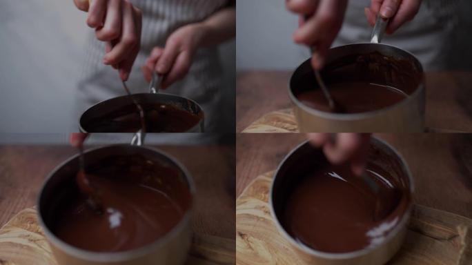 在木板桌子上的平底锅中混合融化的优质液体黑巧克力。用大汤匙搅拌液体热巧克力。