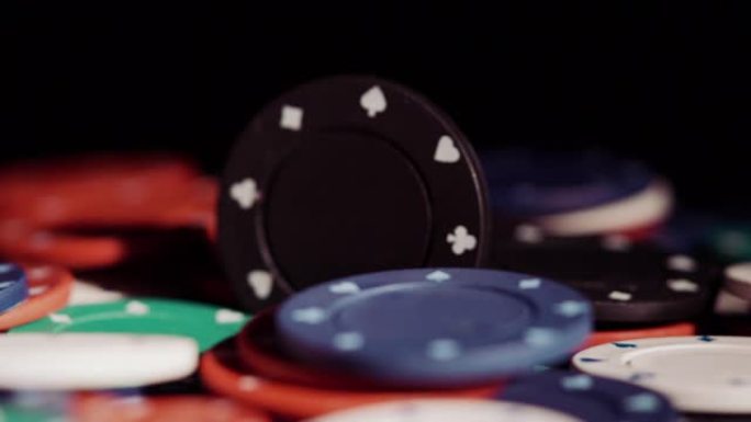 黑色背景下旋转的扑克筹码堆的特写