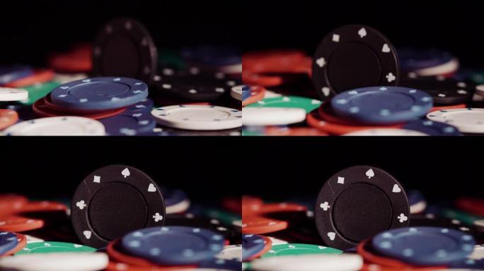 黑色背景下旋转的扑克筹码堆的特写